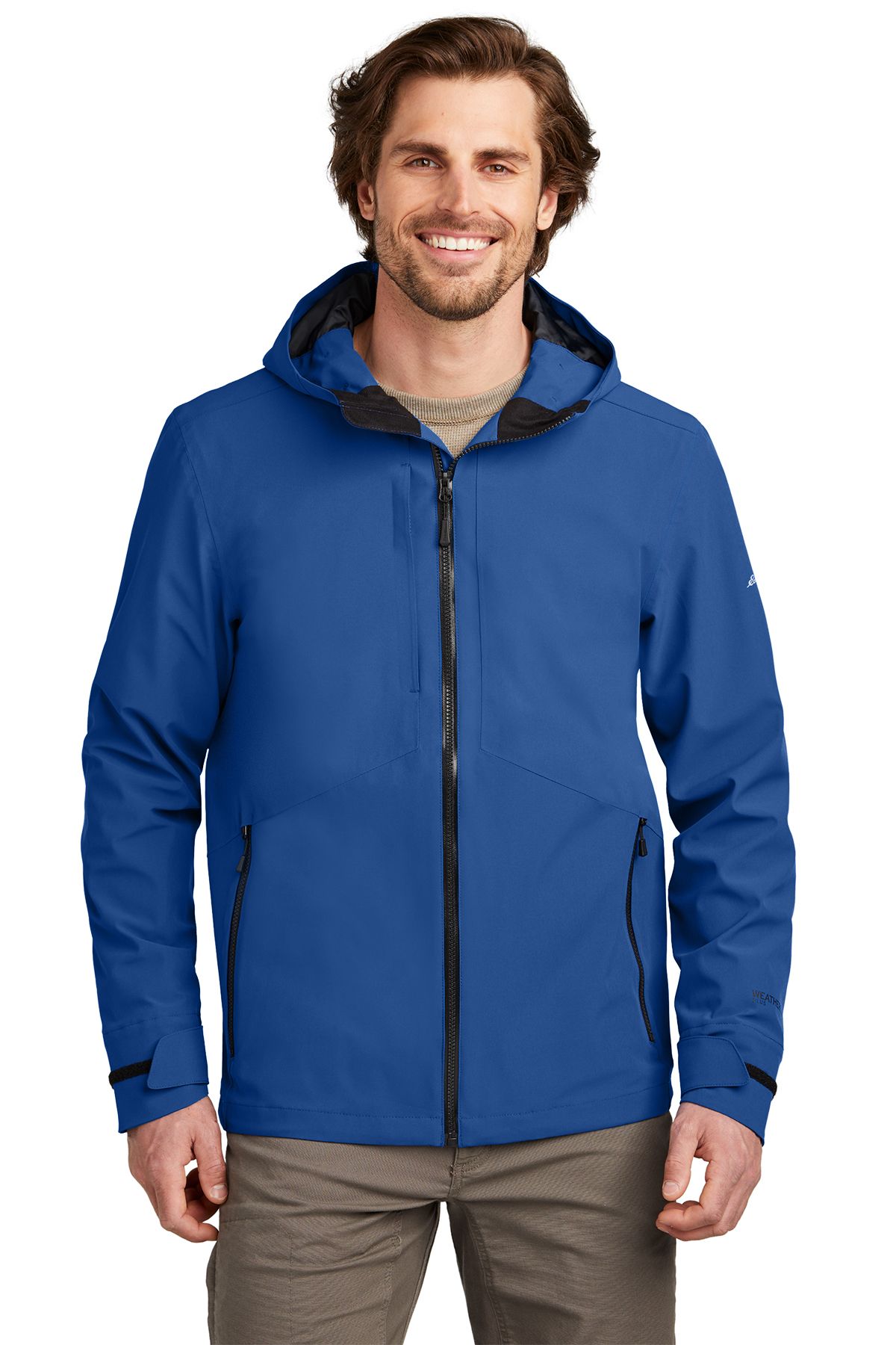Man wearing a gray hooded jacket, smiling.
