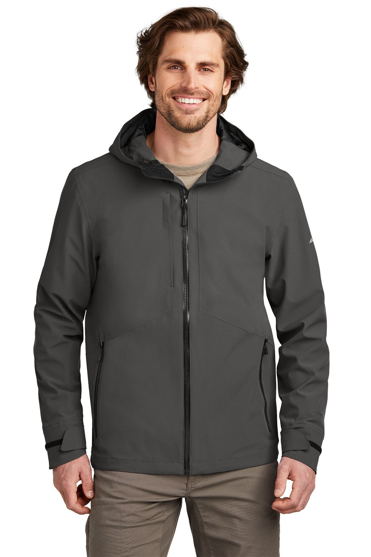 Man wearing a gray hooded jacket, smiling.