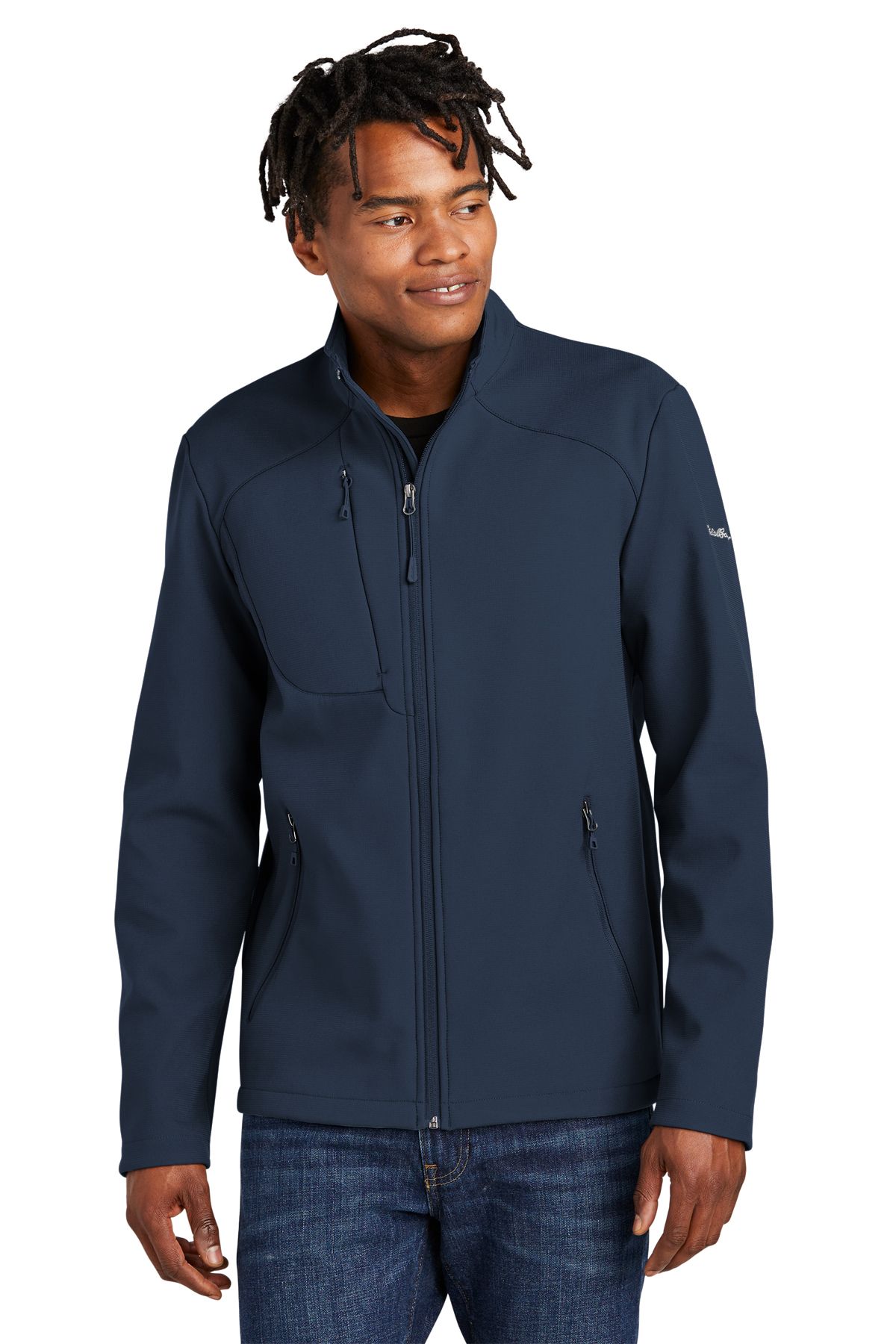 Man wearing a blue zip-up jacket, standing against a white background.