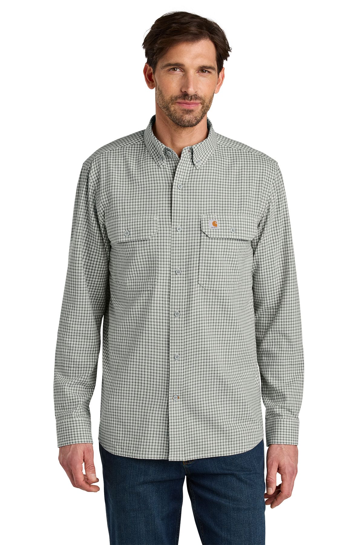 Man wearing a long-sleeve plaid shirt and jeans, standing.