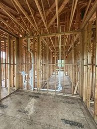 MRJ Plumbing replacing copper and cast iron drain lines. A dug up basement floor with shovels and dirt as well as a plumber making the repair.