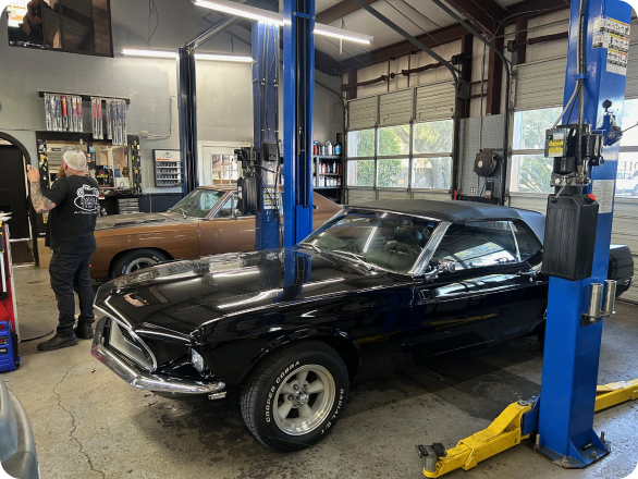 Red Car Infront of Garage | East Hill Automotive, Inc.