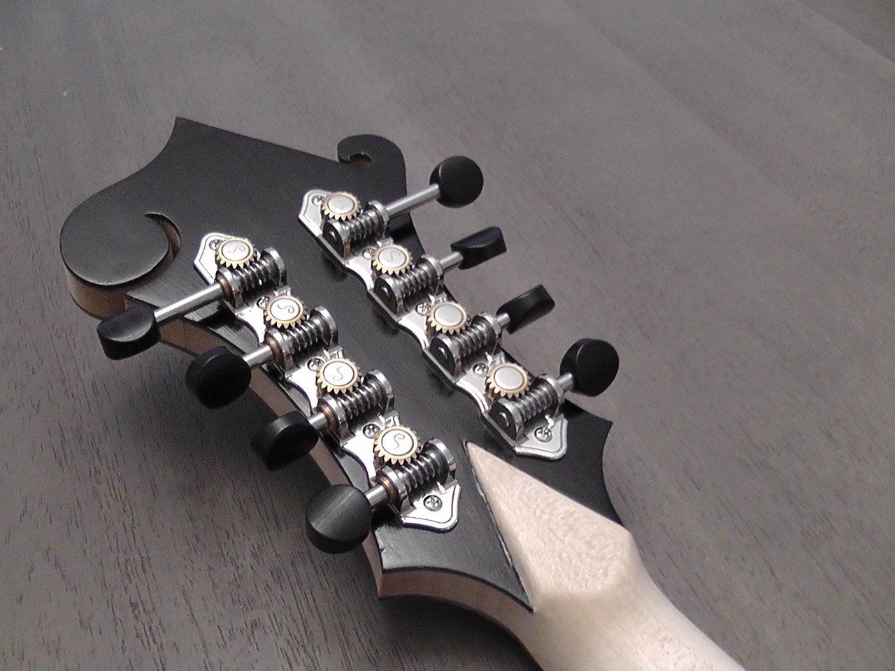 Ebony veneer on back of F5 headstock