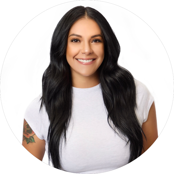 Smiling woman with long dark hair in a white shirt against a plain white background