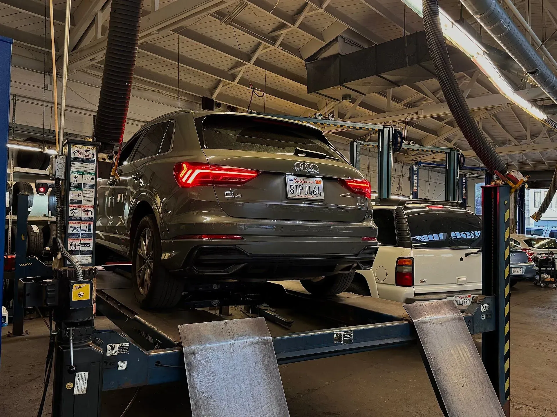Audi SUV Positioned On Lift Inside Service Bay | Brake And Wheel Service Center LLC