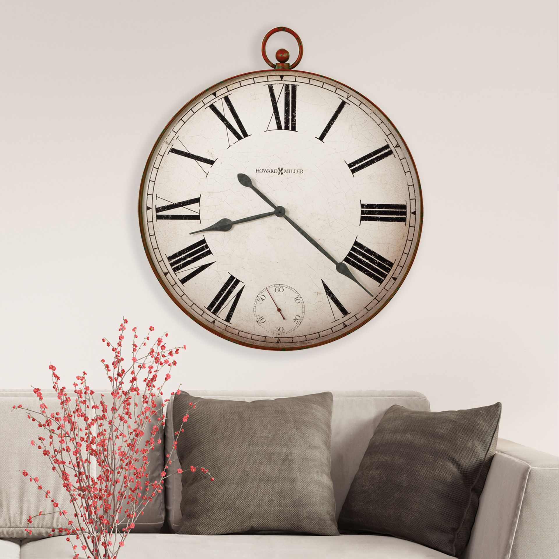 A living room with a couch and a clock on the wall
