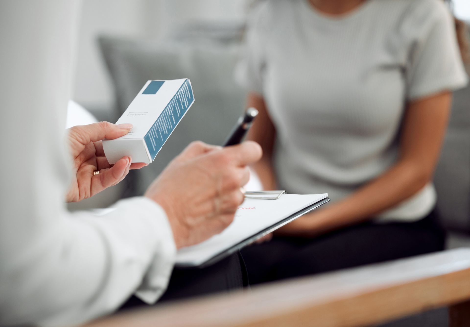 An unrecognizable specialist sitting and prescribing an addiction treatment method to a patient. An unrecognizable specialist sitting and prescribing an addiction treatment method to a patient.