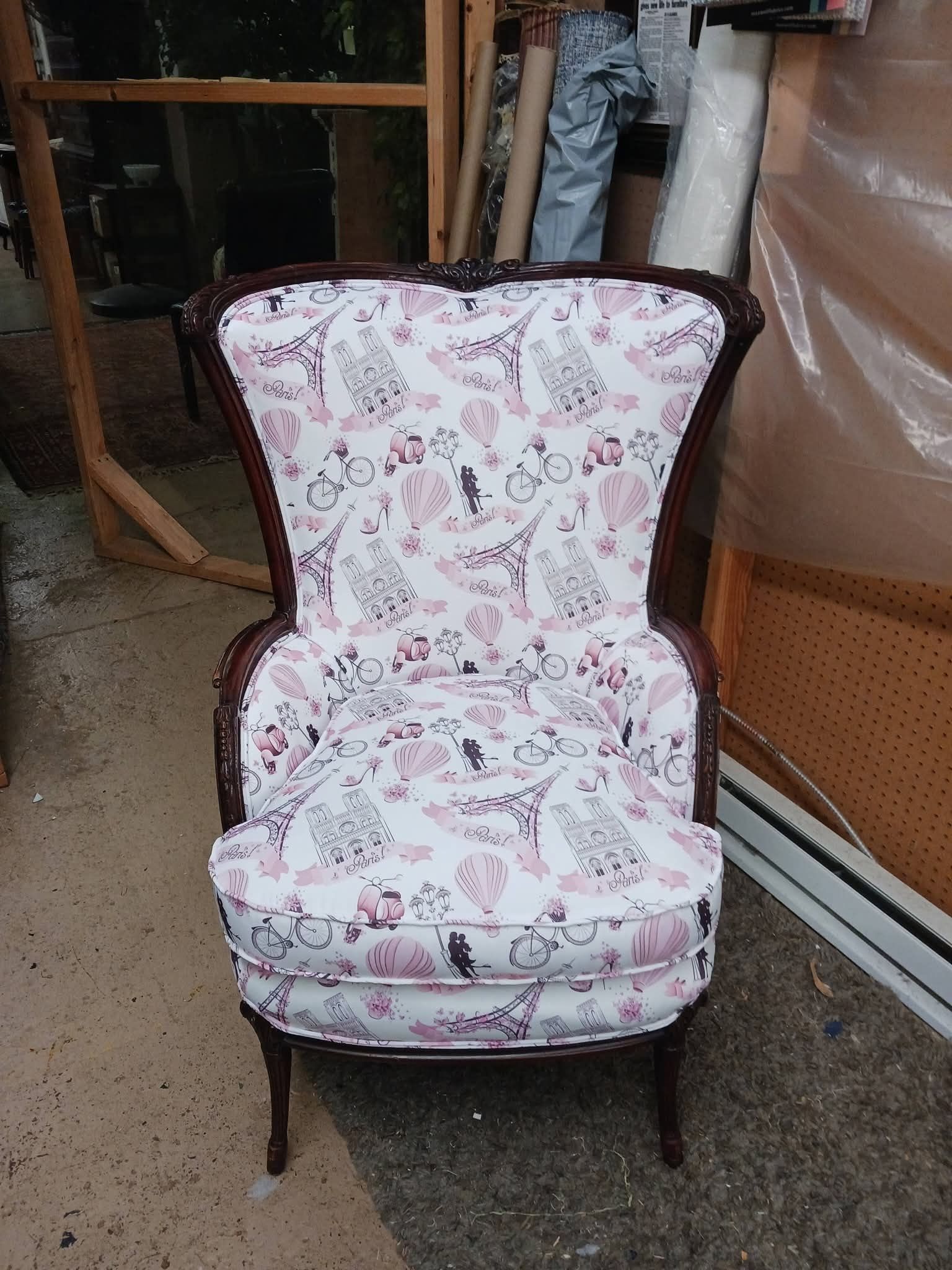 Floral upholstered accent chair in a garage or workshop setting