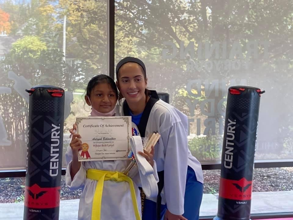 Two women are standing next to each other holding a certificate.