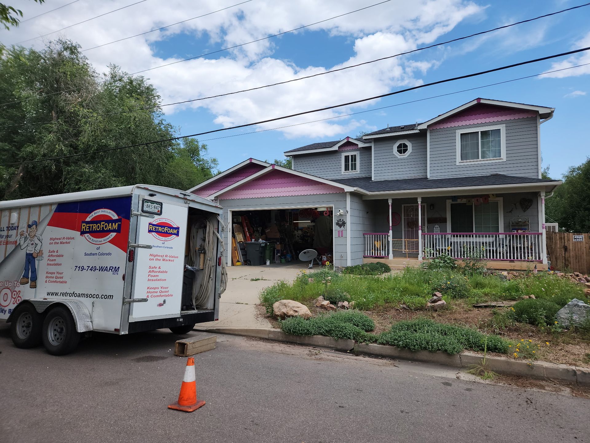 Food truck trailer parked in a residential driveway beside a red SUV and a house.