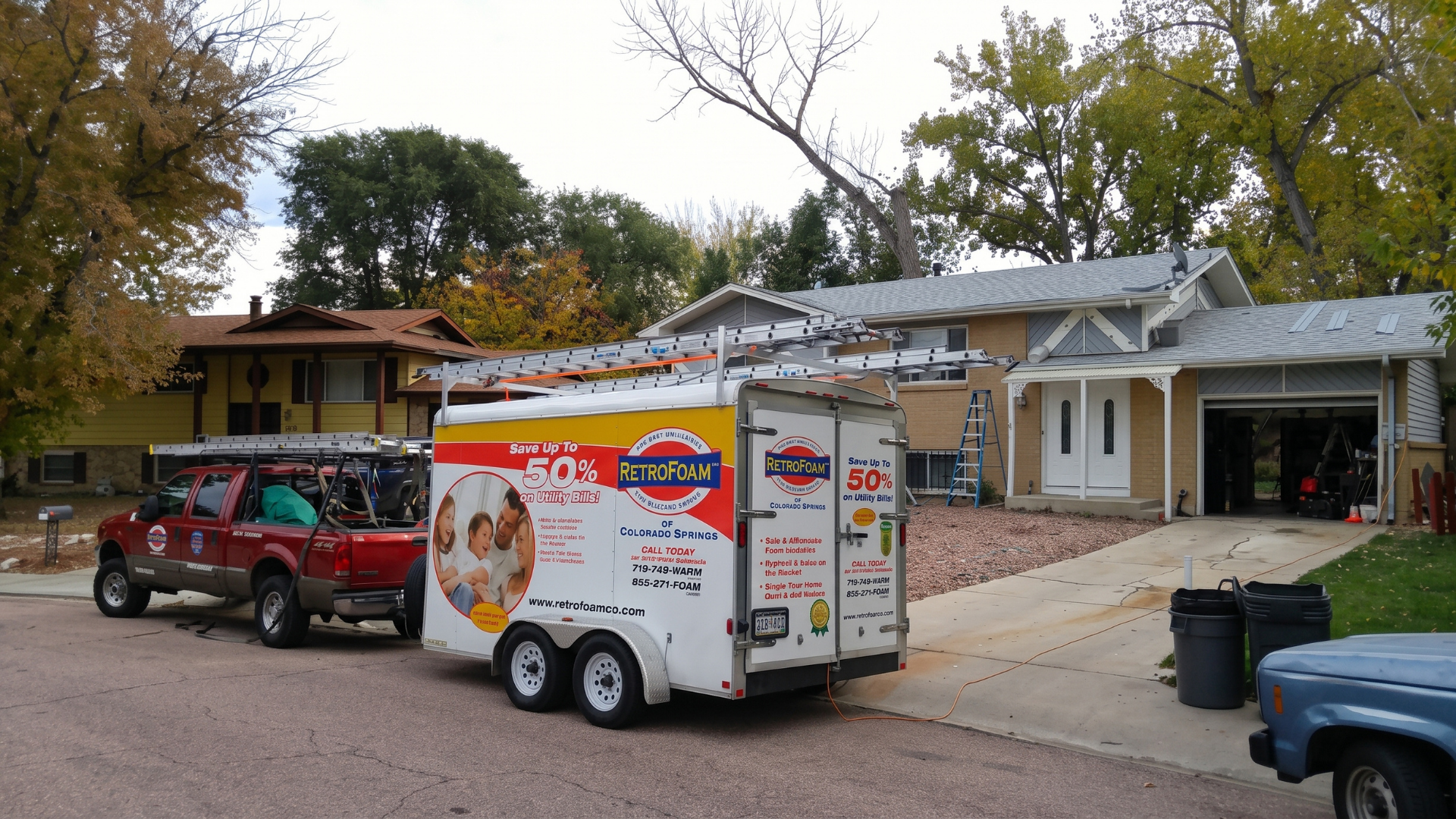 Food truck trailer parked in a residential driveway beside a red SUV and a house.