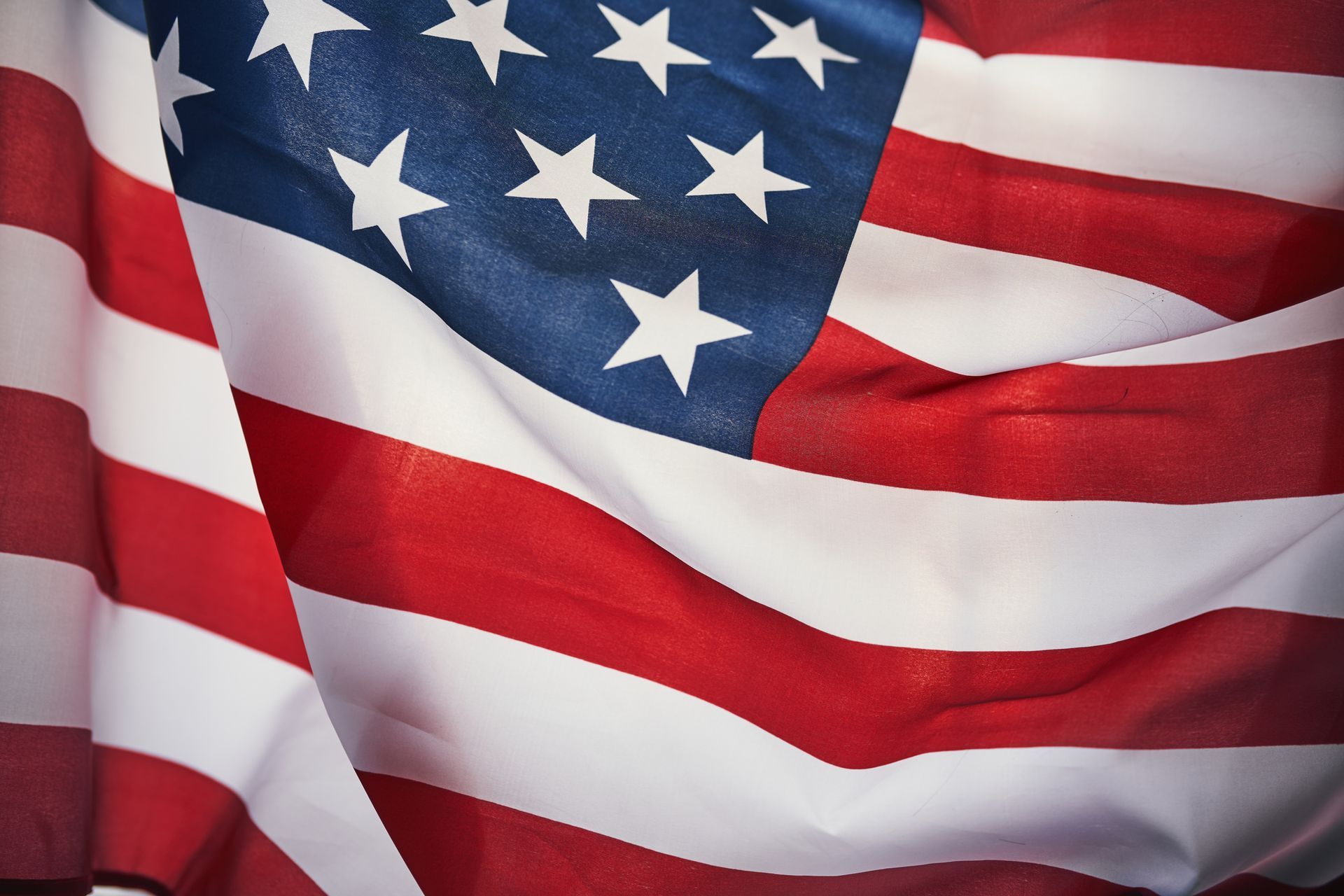 American flag with red and white stripes and a blue square with white stars.