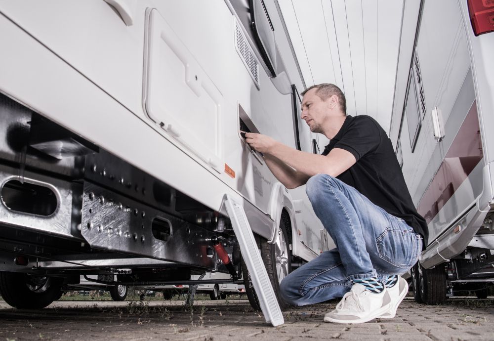 preparing his travel trailer for the season inside rv storage