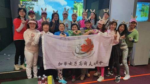 A group of people are posing for a picture with a flag.