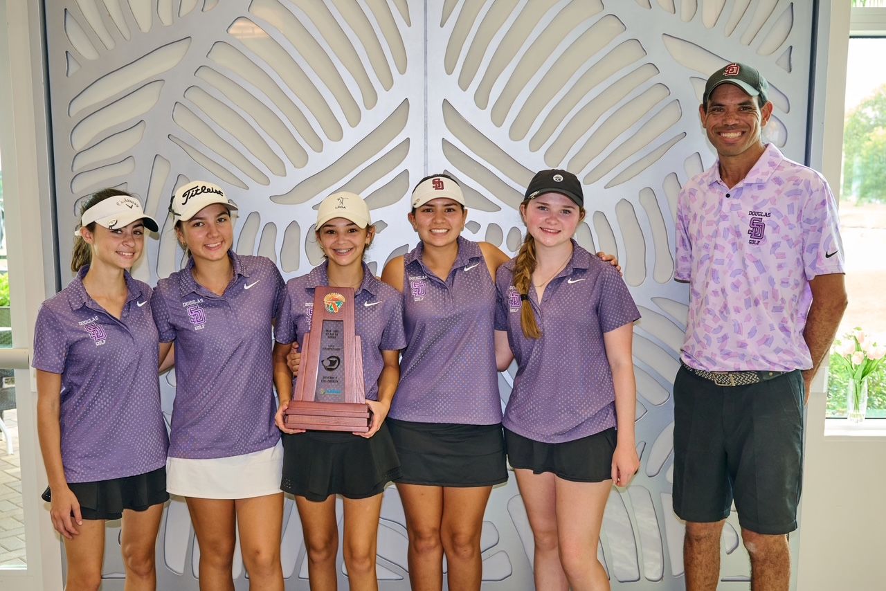 Coach Jonathan Smith and the State Champion Marjory Stoneman Douglas High School Girls Varsity Golf Team A group of young women standing next to each other holding a trophy.