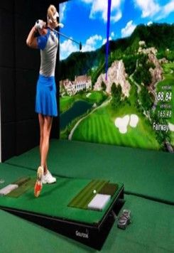 A woman in a blue skirt is swinging a golf club