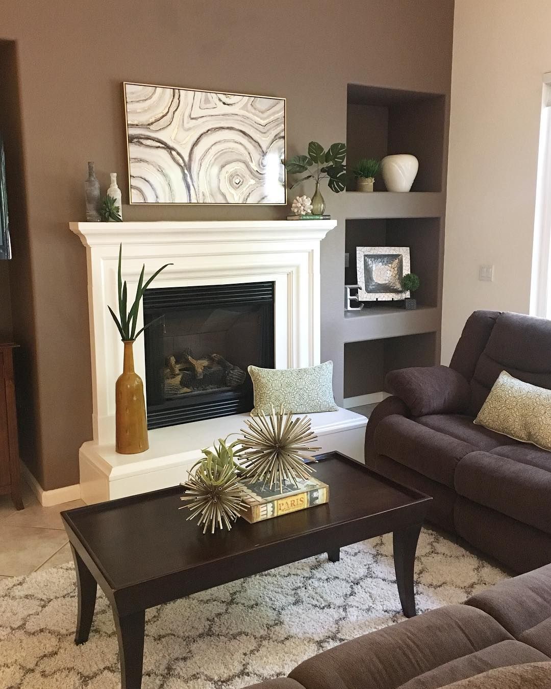 A living room with a fireplace , couch and coffee table