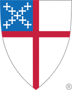 Shield-shaped emblem with a red cross on a white background, a blue square in the upper left with white crosses.