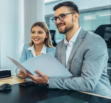 Two professionals smiling during a job interview conversation