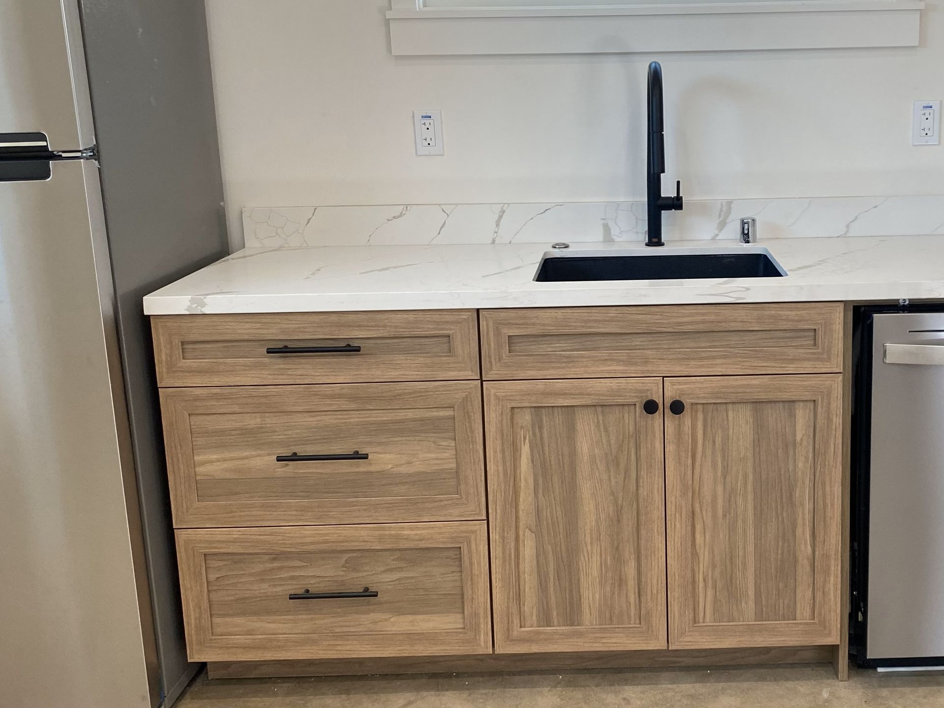 A kitchen with wooden cabinets and a sink