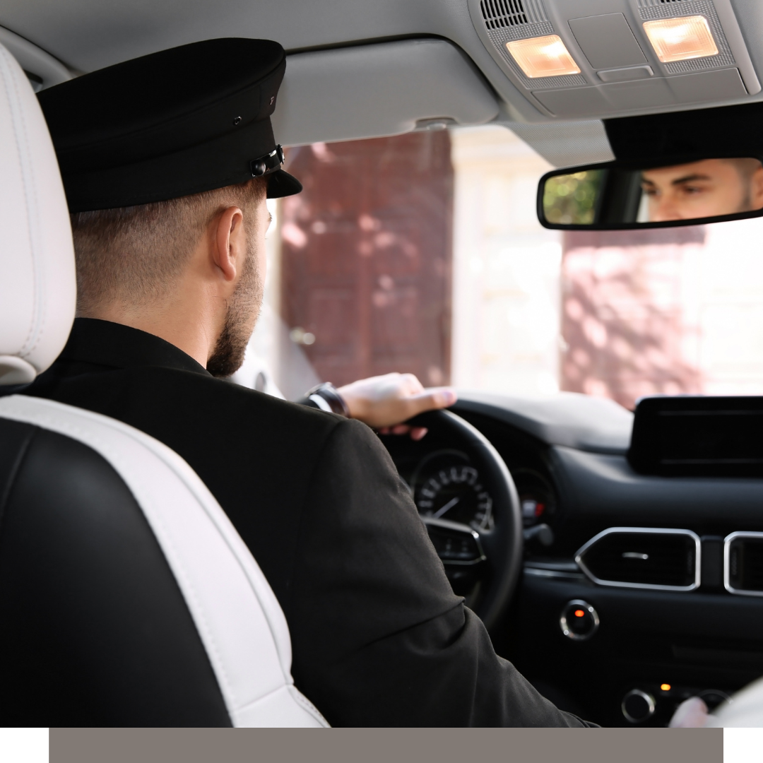 Police officer driving a car, seen from the back seat inside the vehicle