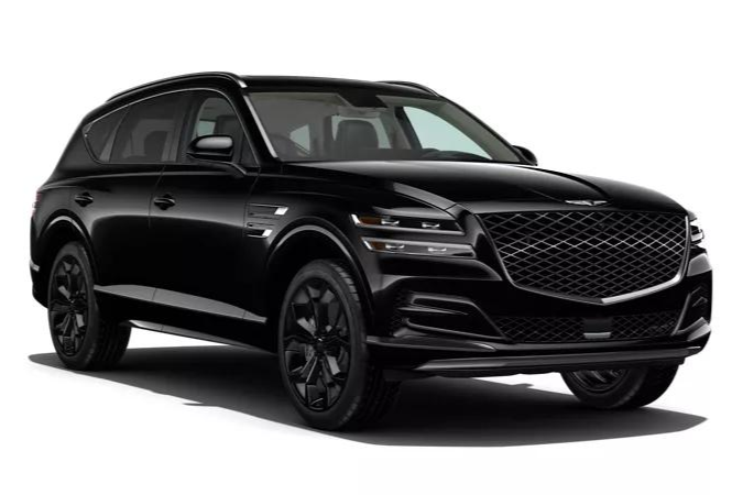 Black Chevrolet SUV parked on a wet lot under an overcast sky