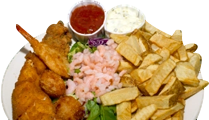 Plate of fried fish, shrimp, fries, and sauces.