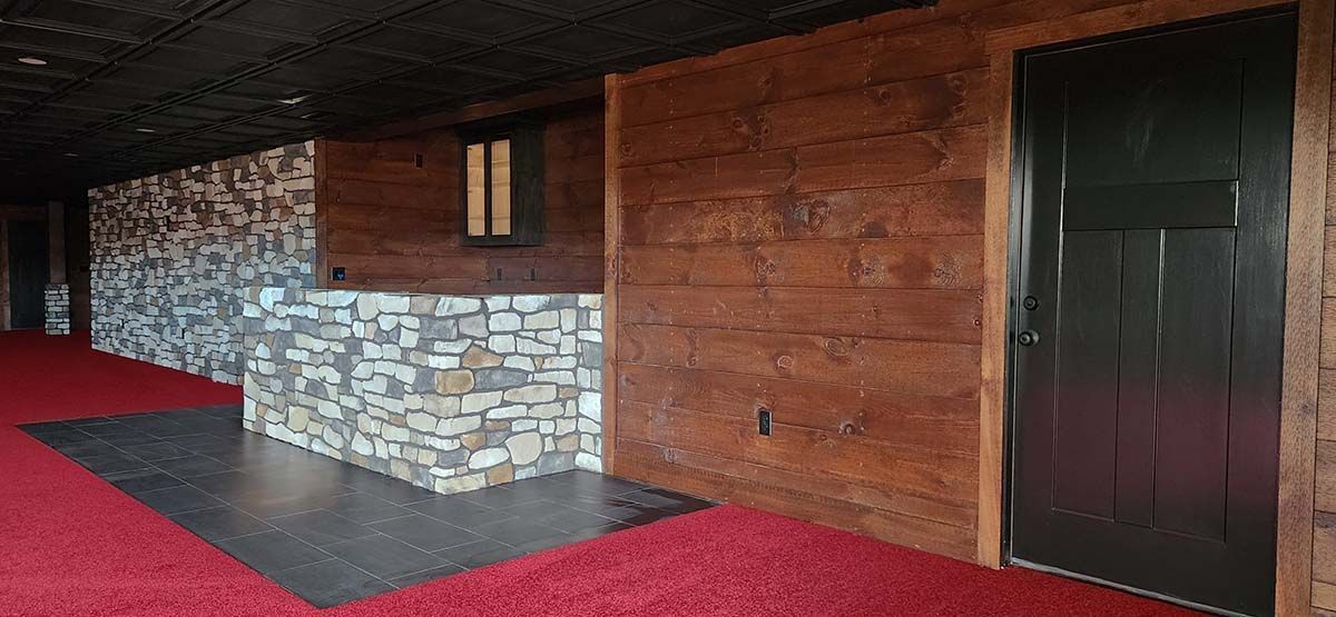 wooden wall with stone wall, tile and red carpet