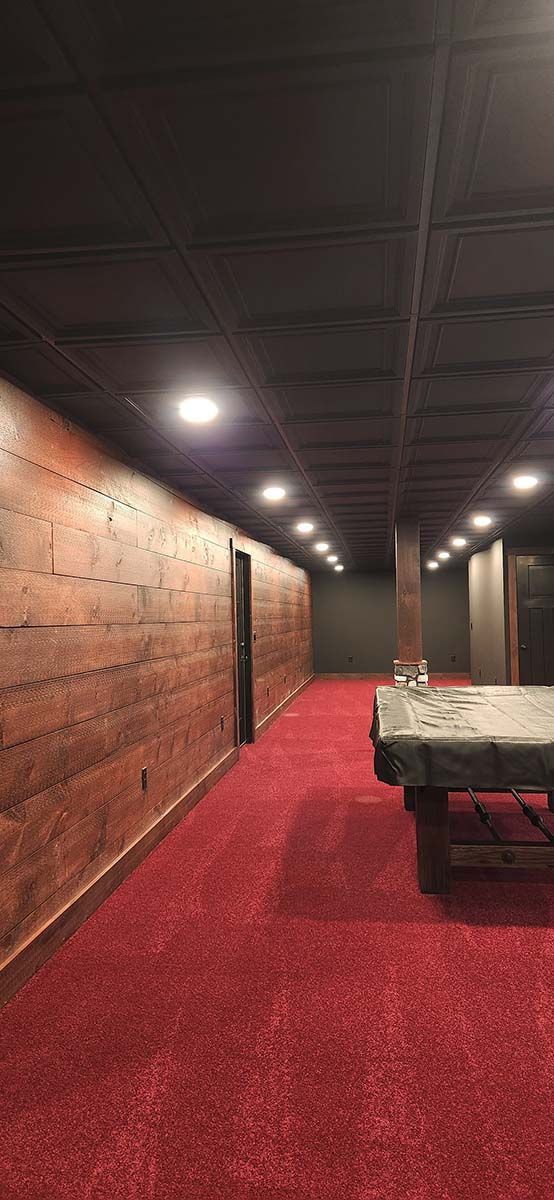 wooden walls, red carpet and accent wall