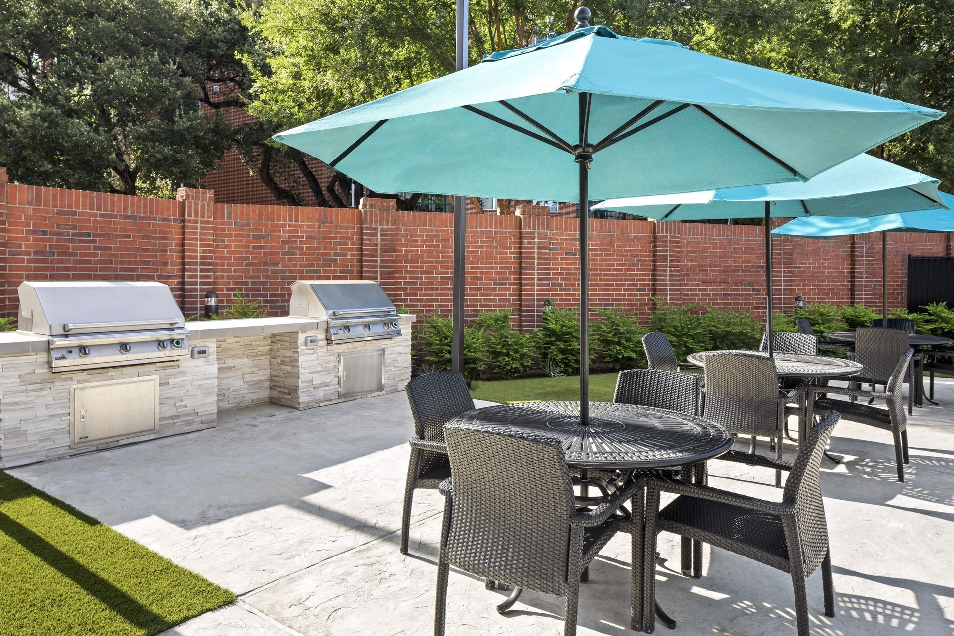 Outdoor dining area with umbrellas and grills