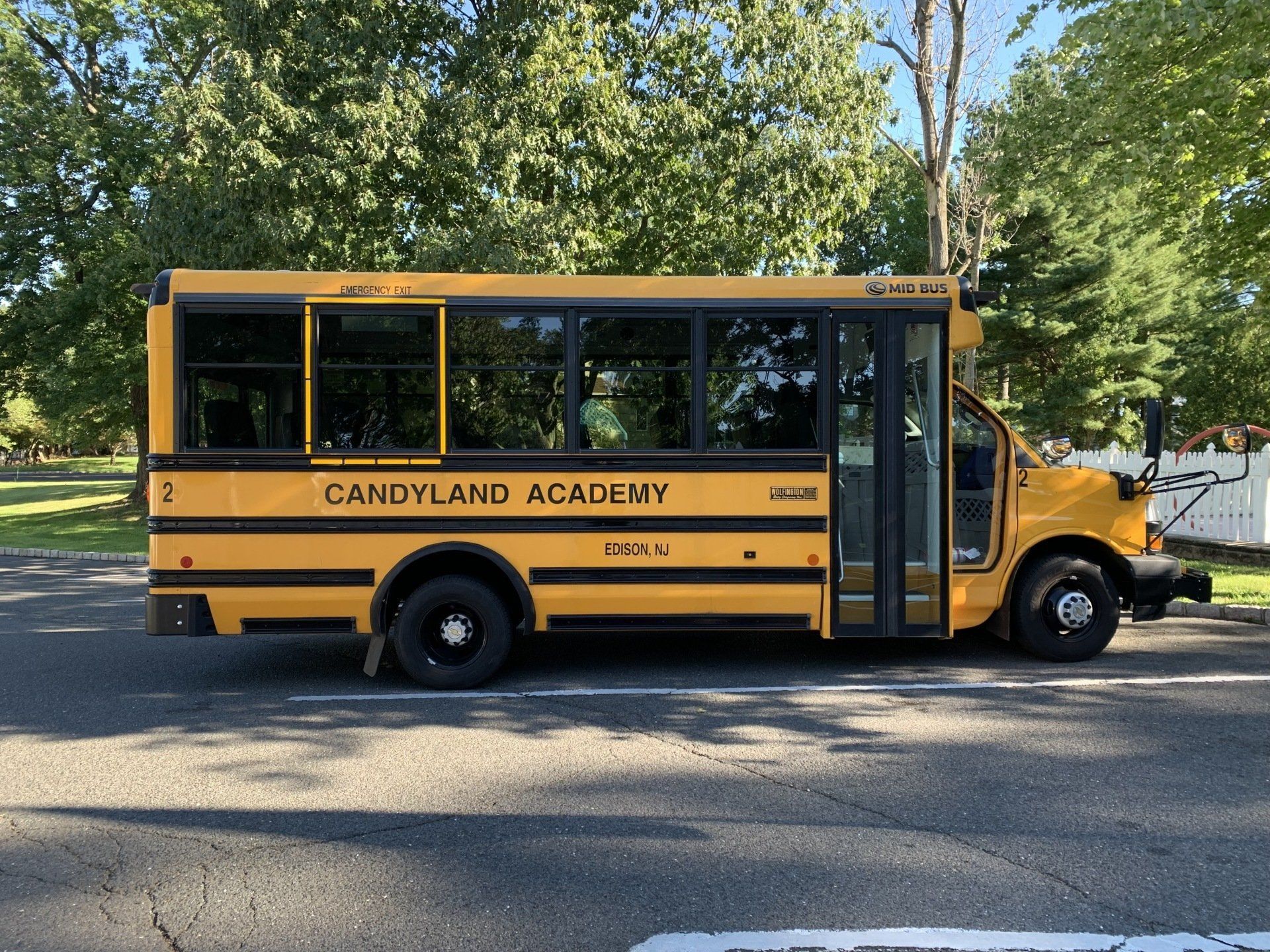 A yellow school bus is parked on the side of the road.