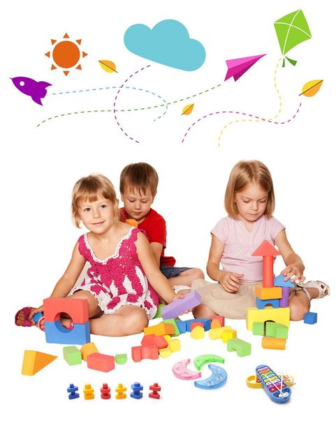 Three children are sitting on the floor playing with blocks.