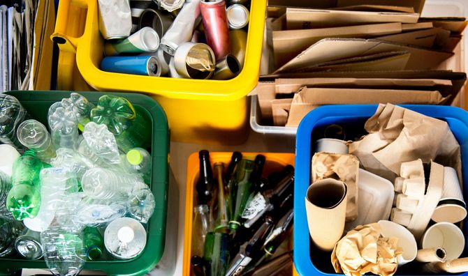 Recycling bins, sorted by material: plastics in green, metals in yellow, paper in white, and mixed paper in blue. Recycling bins, sorted by material: plastics in green, metals in yellow, paper in white, and mixed paper in blue.