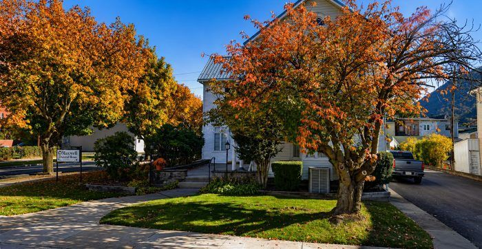 Exterior of Beech Creek, PA funeral home and cremations with Maxwell Funeral Home and autumn trees