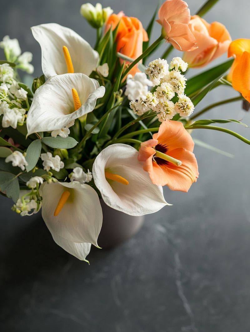 Sympathy flowers for Beech Creek, PA funeral services with white calla lilies and peach blooms