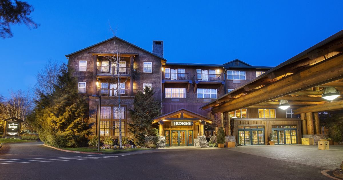 A large brick building with a lot of windows is lit up at night.