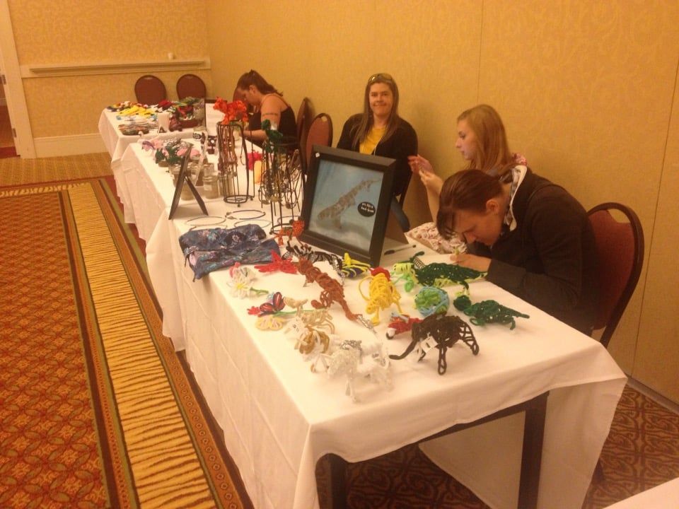 A group of people are sitting around a table with toys on it