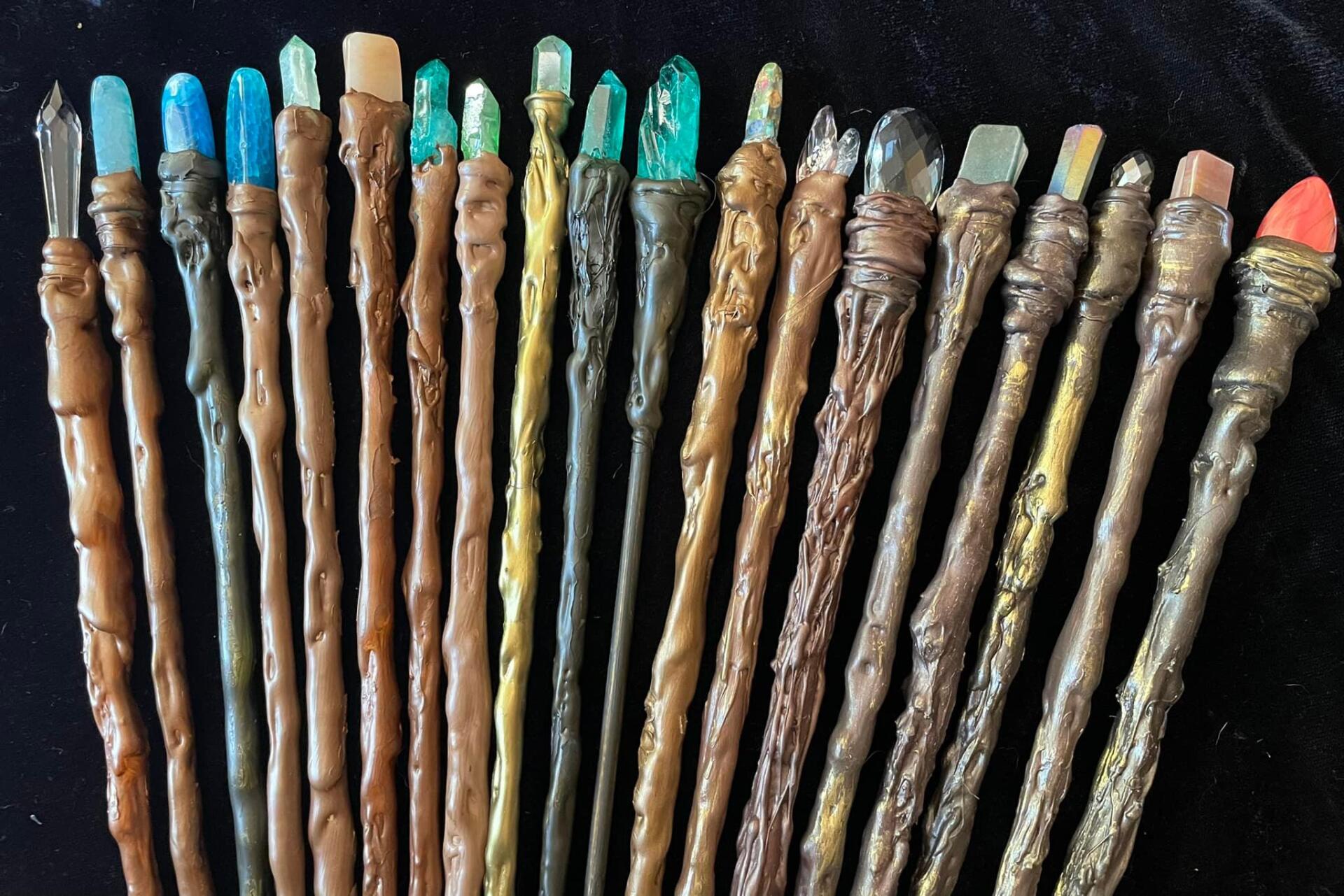 A bunch of wands are lined up on a table