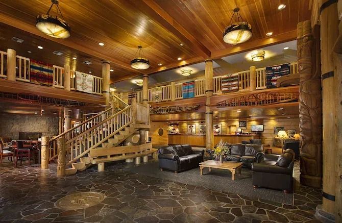 Rustic Heathman Lodge lobby with log beams, stone floors, and leather seating.