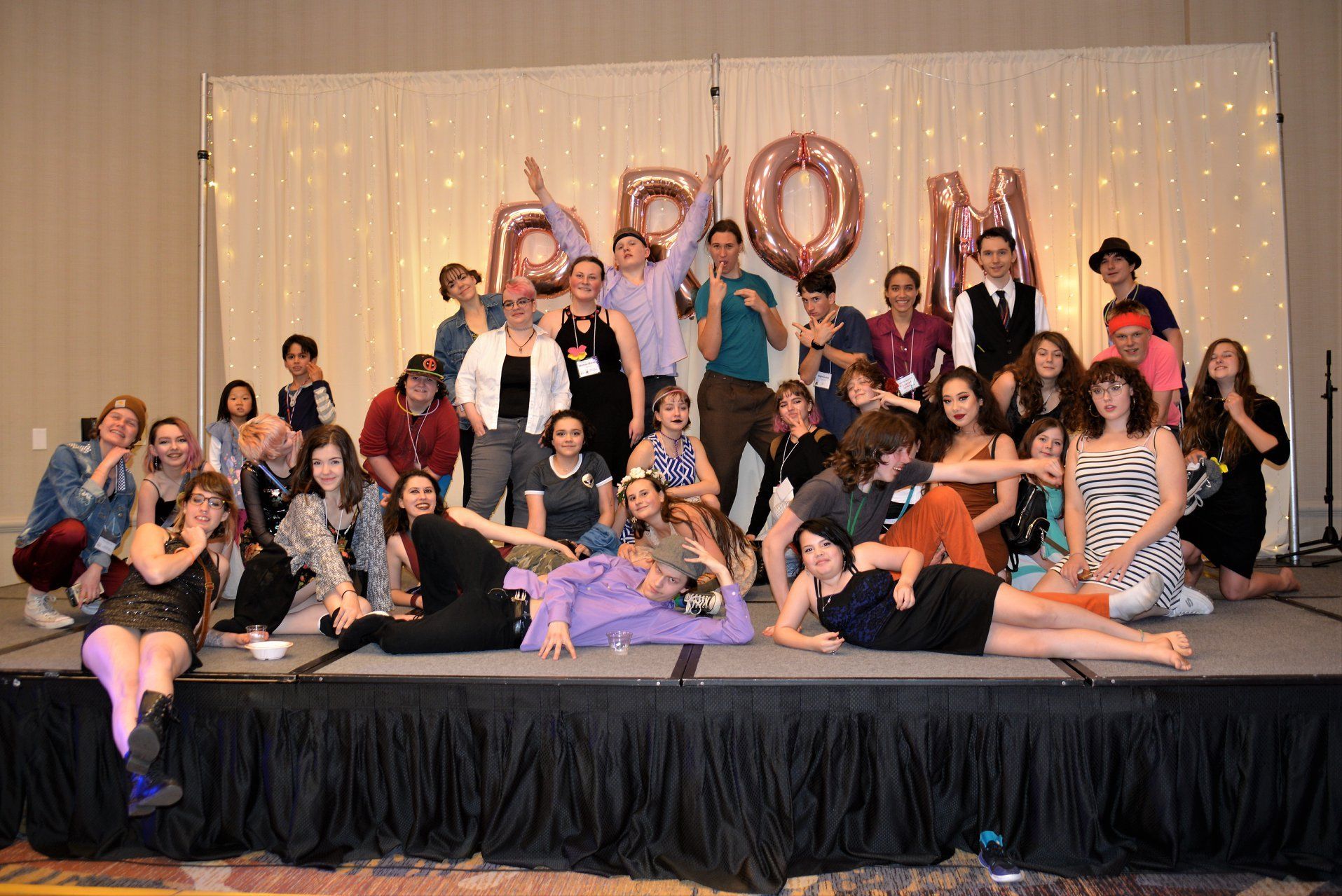 A group of people are posing for a picture on a stage.