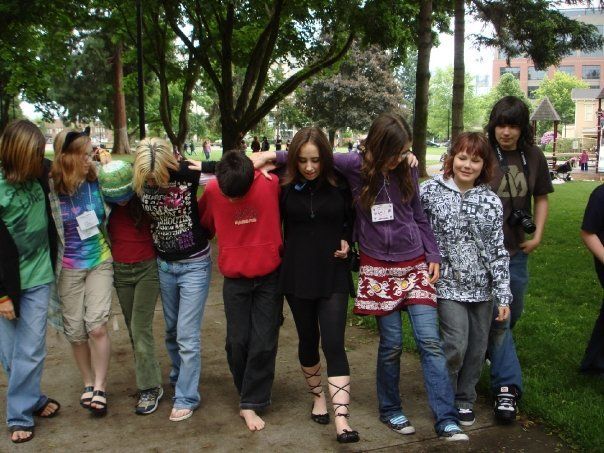 A group of young people are walking down a path together