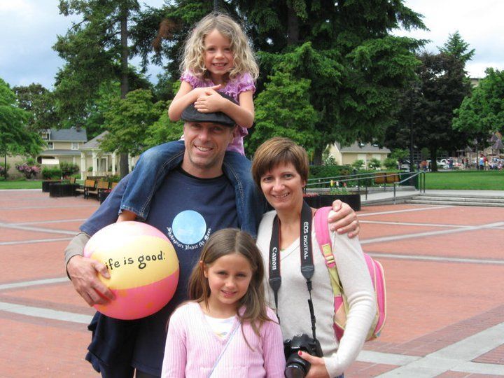 A man is holding a beach ball that says life is good