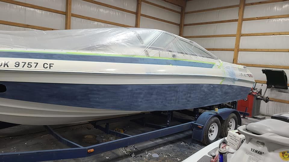 A boat is sitting on a trailer in a garage.