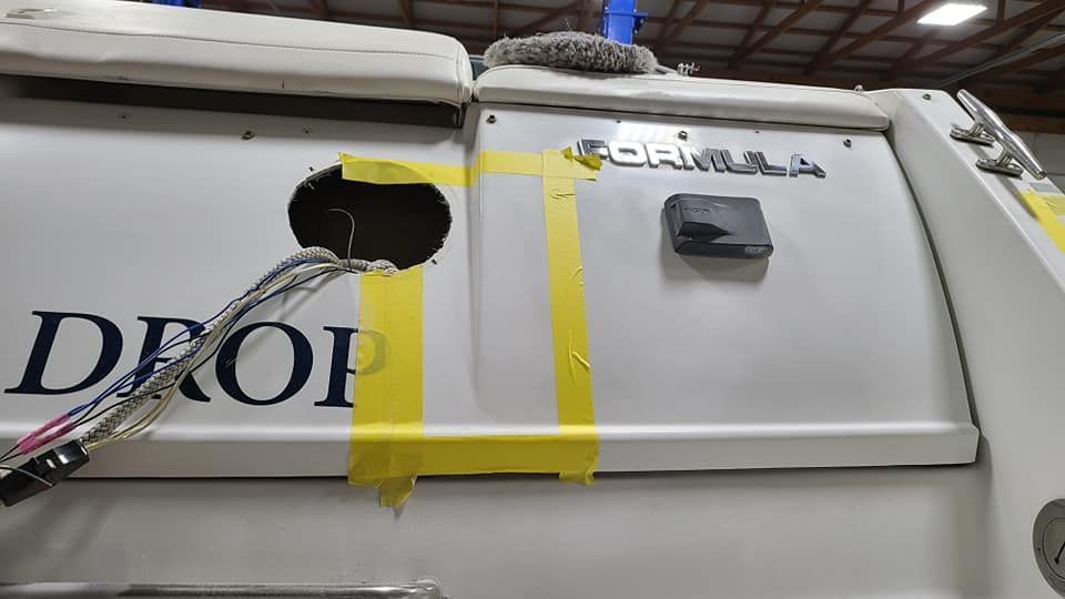 A white boat with the word drop taped to it.