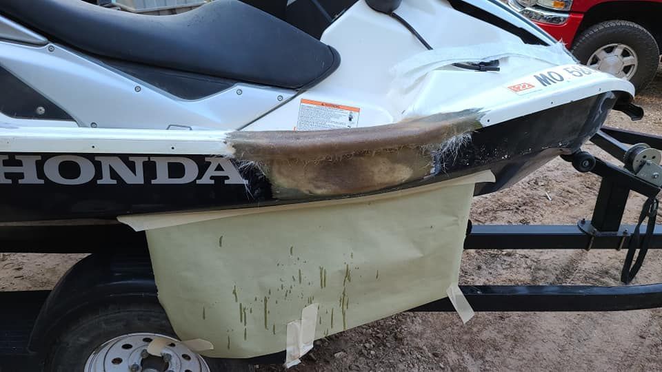 A honda jet ski is sitting on a trailer.