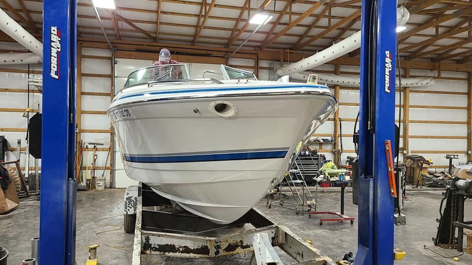 A boat is sitting on a lift in a garage.