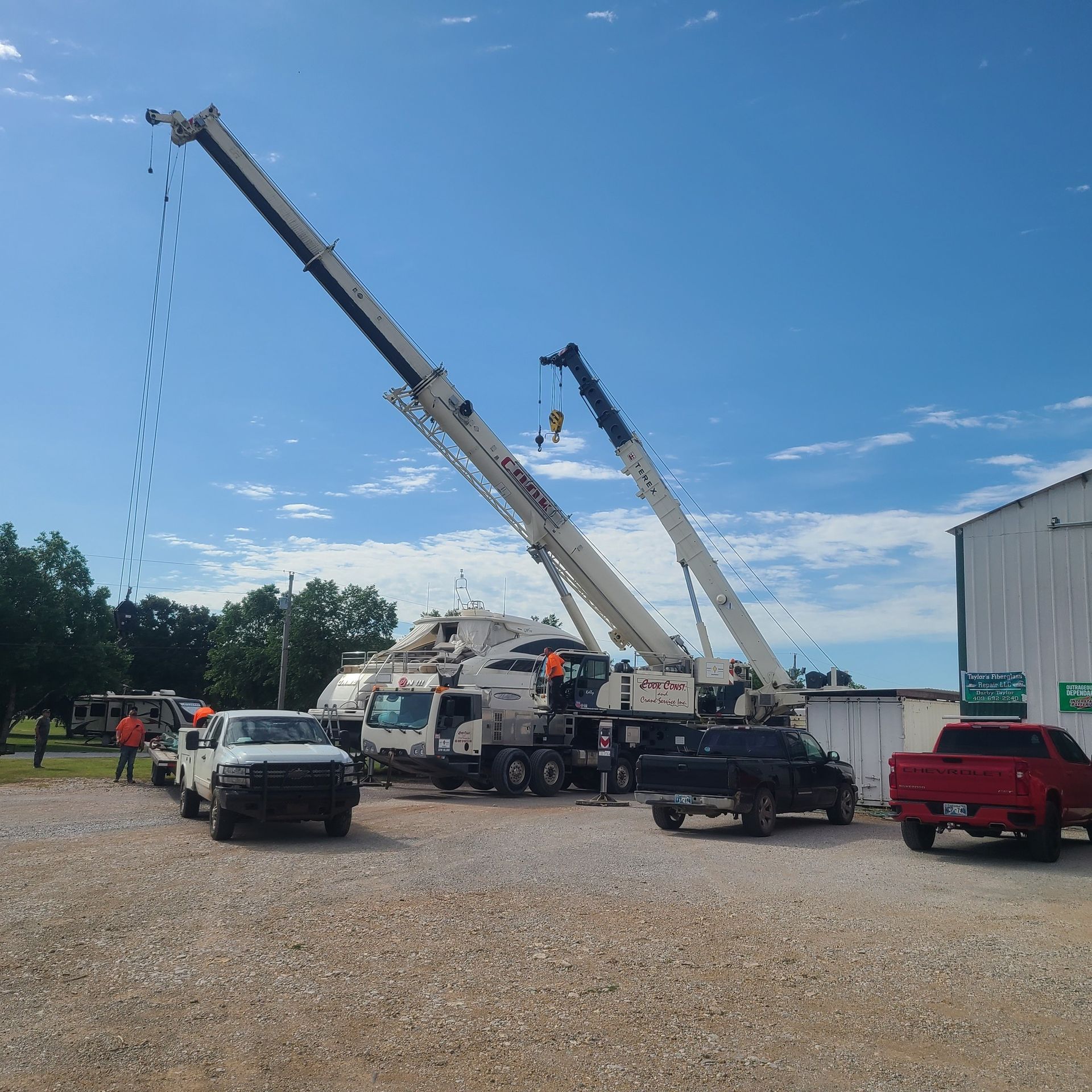 A red truck is parked in front of a crane