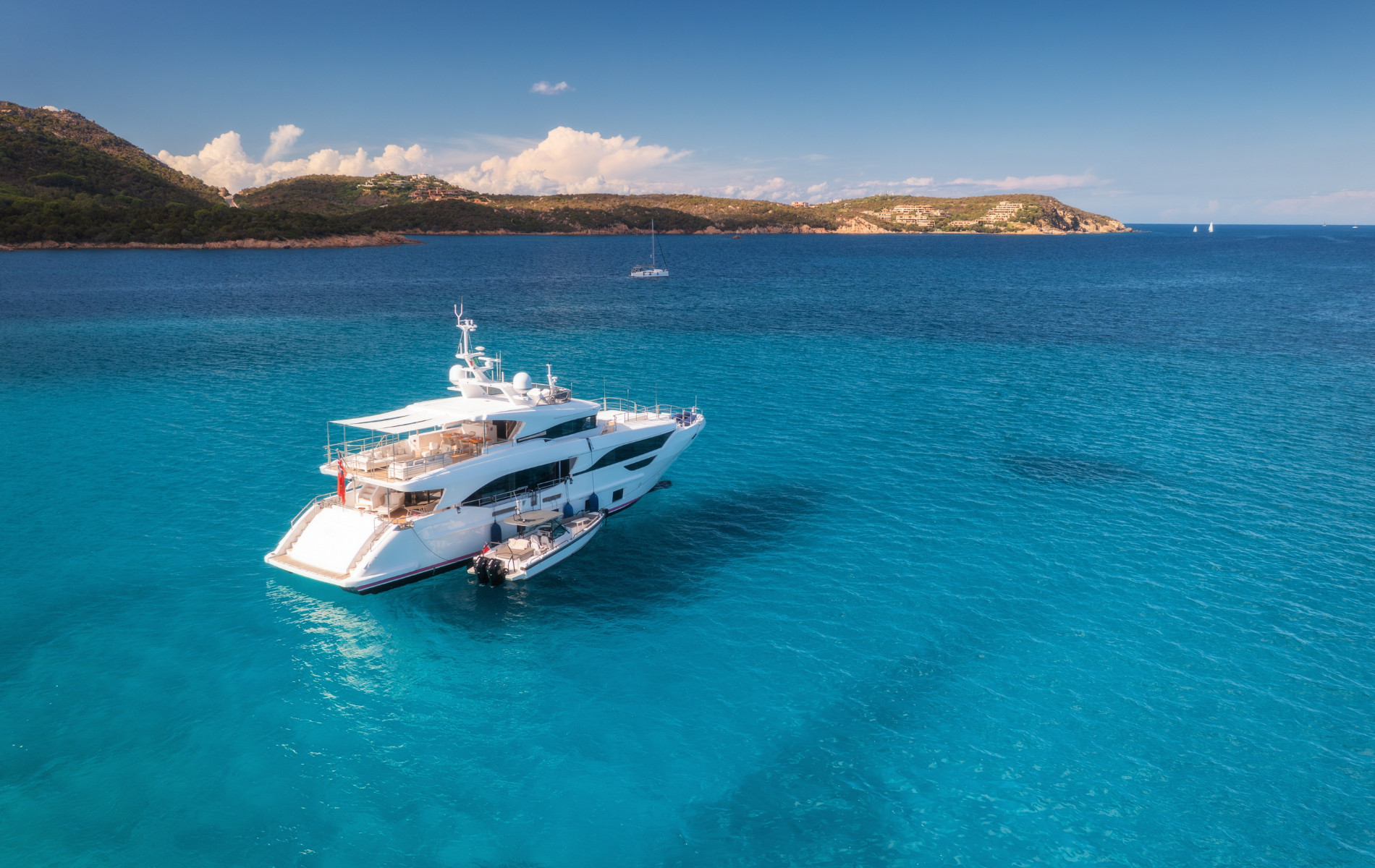 An aerial view of a large yacht in the middle of the ocean.