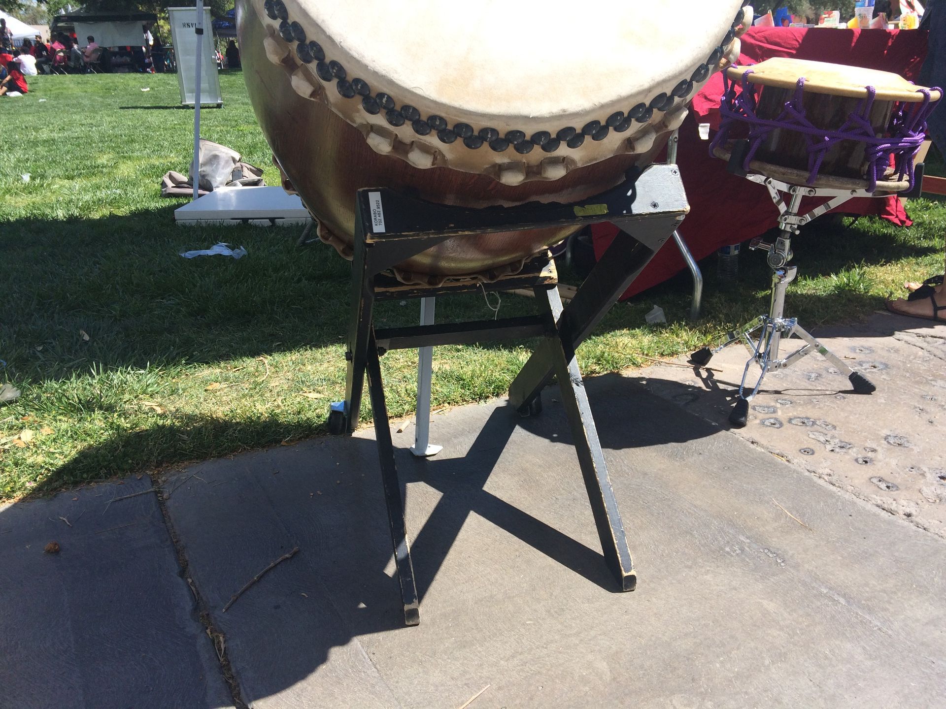 A taiko drum on a slanted taiko stand on concrete