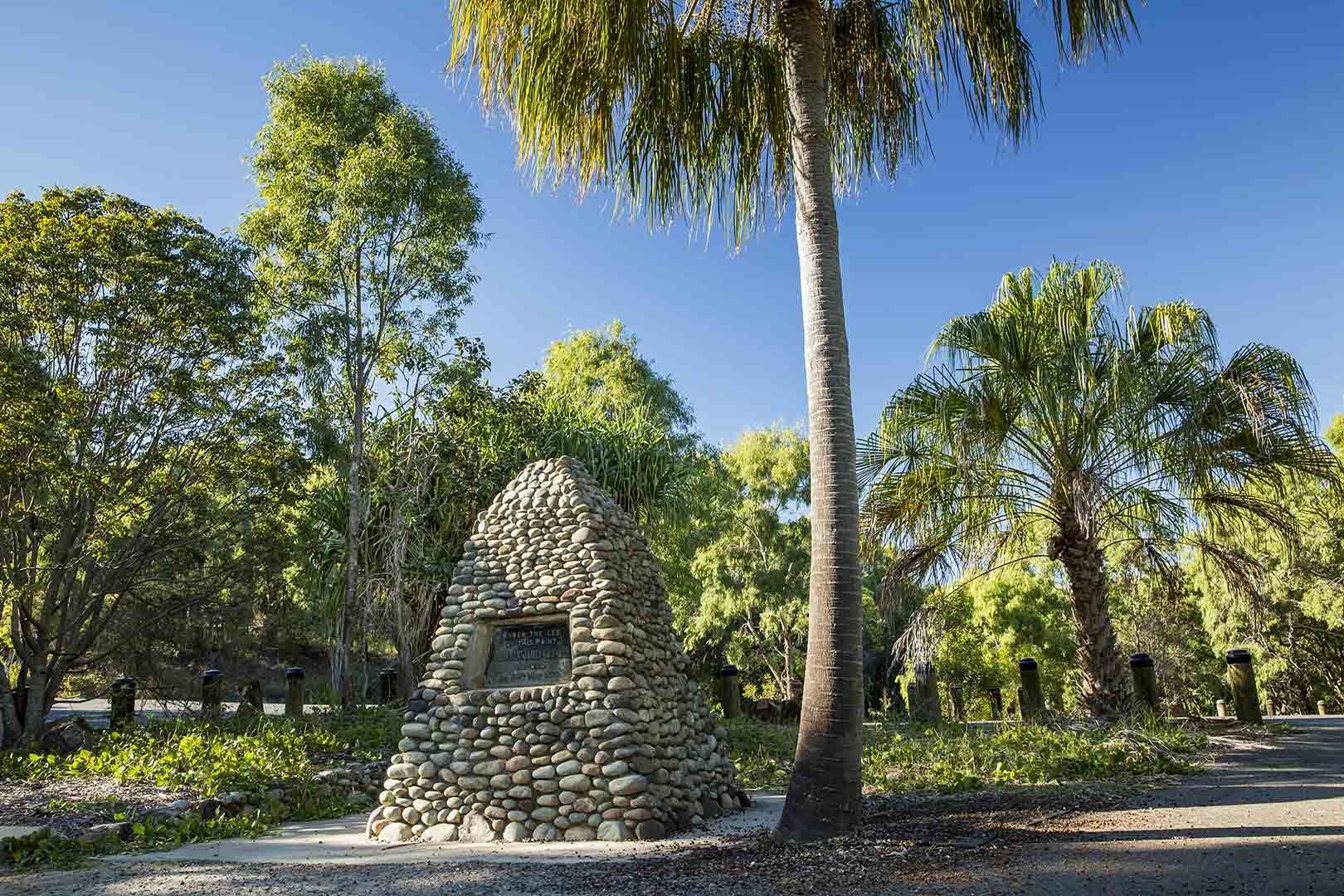 A Stone Sculpture Is Surrounded By Trees In A Park — CAL AUTO Mobile Roadworthys in Bundaberg, QLD
